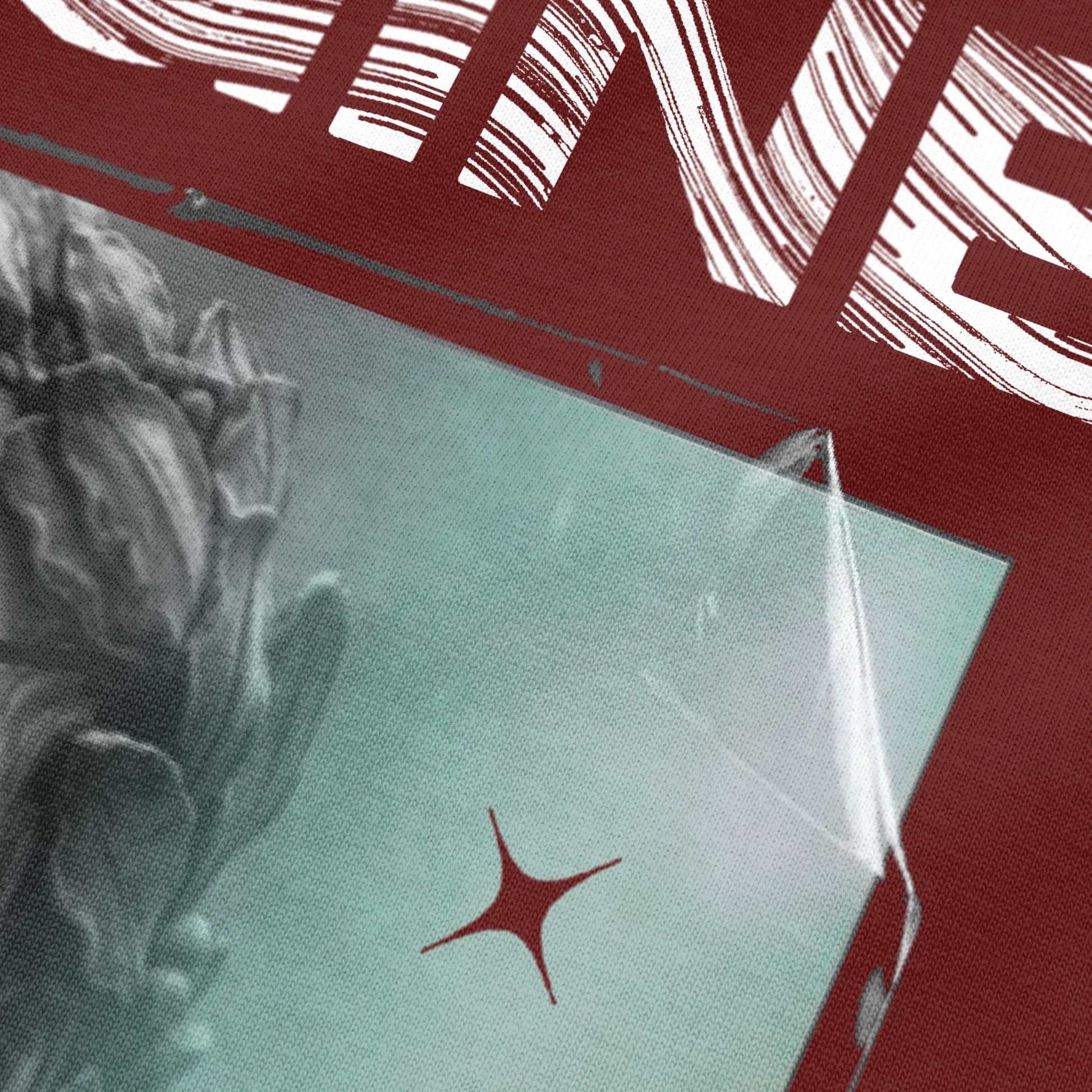 Close-up view of sculpture artwork on wine oversized t-shirt by BLAACK