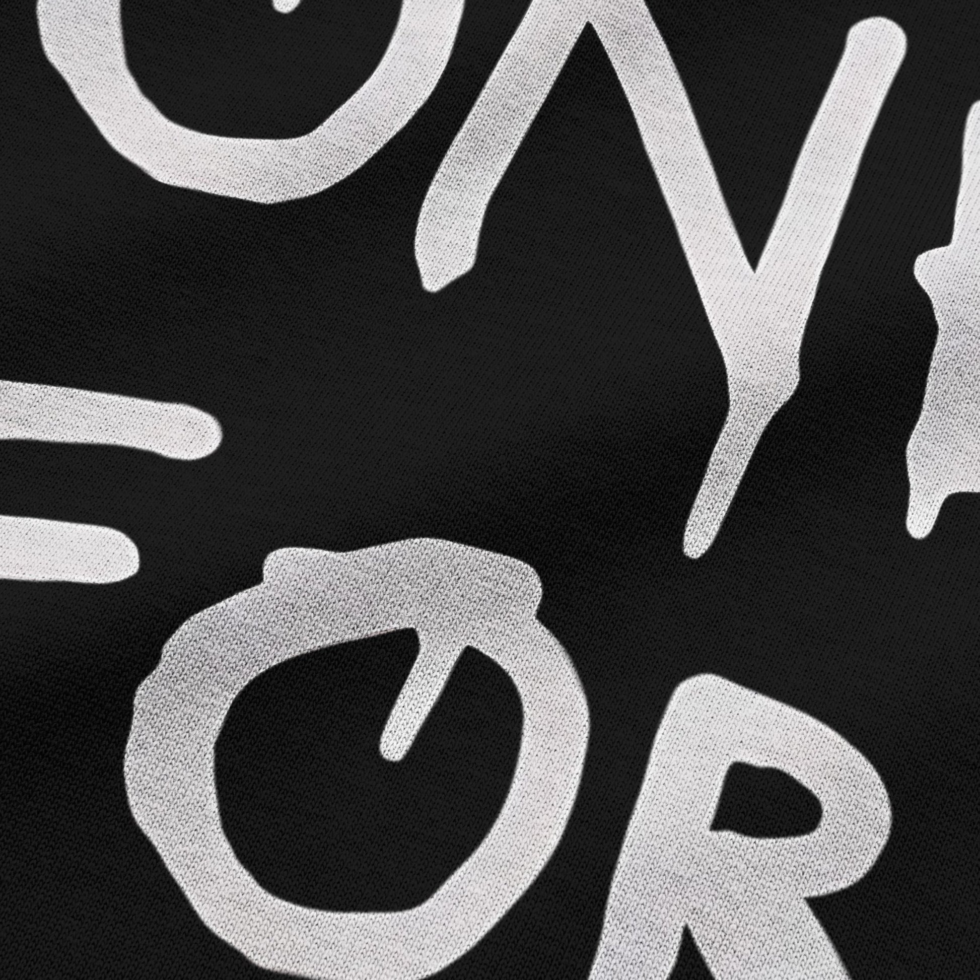 Close-up view of NEED MONEY FOR BMW typography on black oversized t-shirt by BLAACK