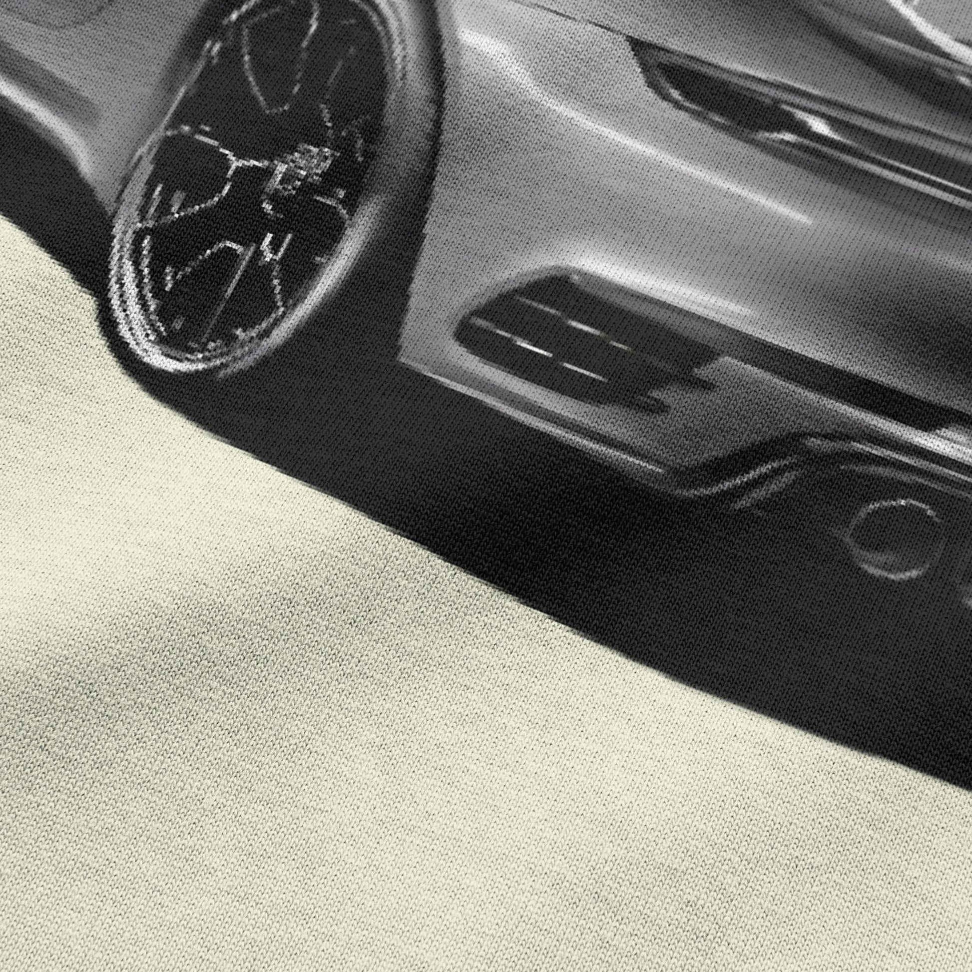 Close-up view of car graphic on beige oversized t-shirt by BLAACK