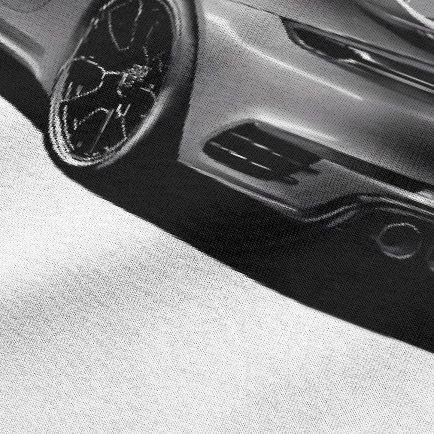 Close-up view of car graphic on white oversized t-shirt by BLAACK