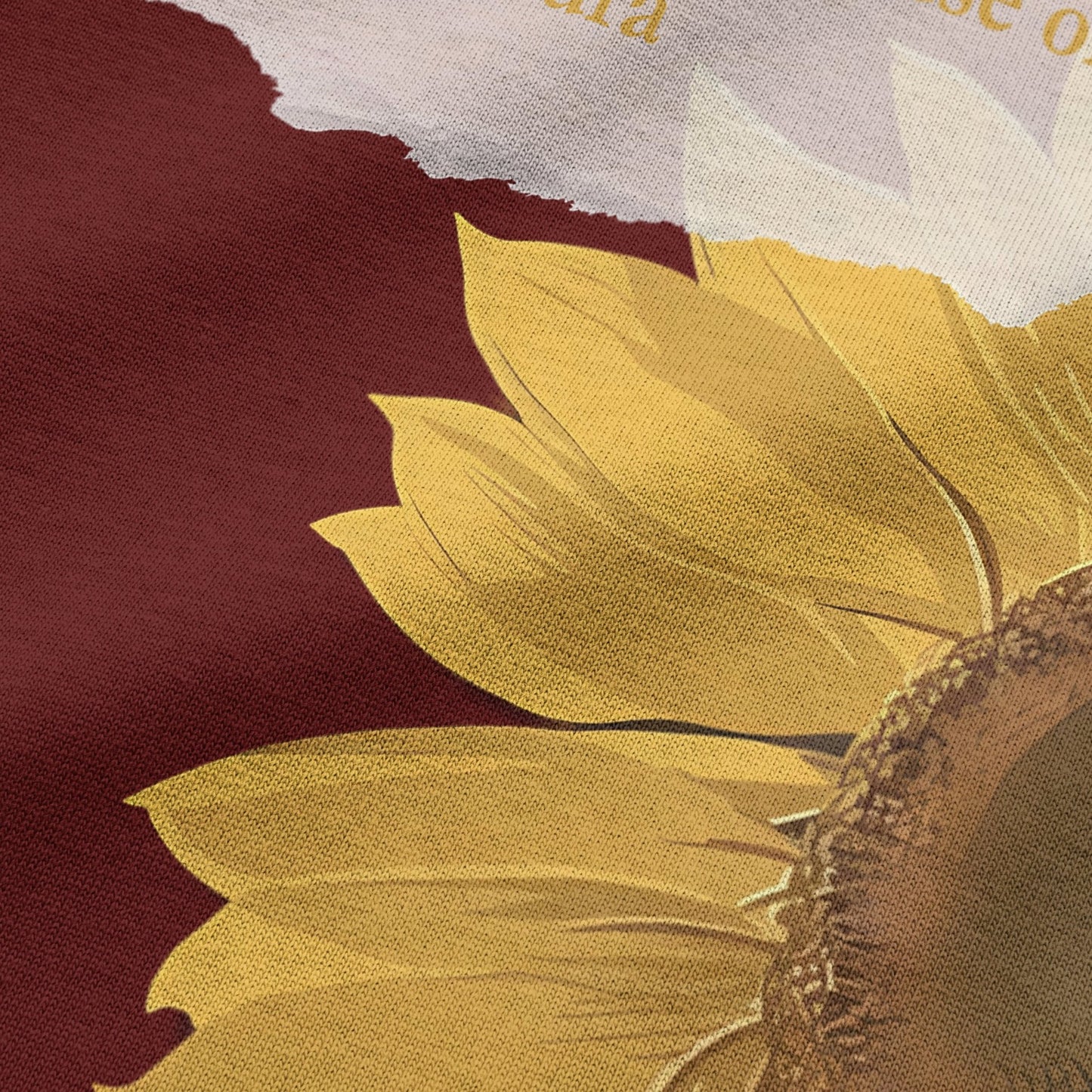 Close-up of sunflower graphic print on wine oversized t-shirt by BLAACK
