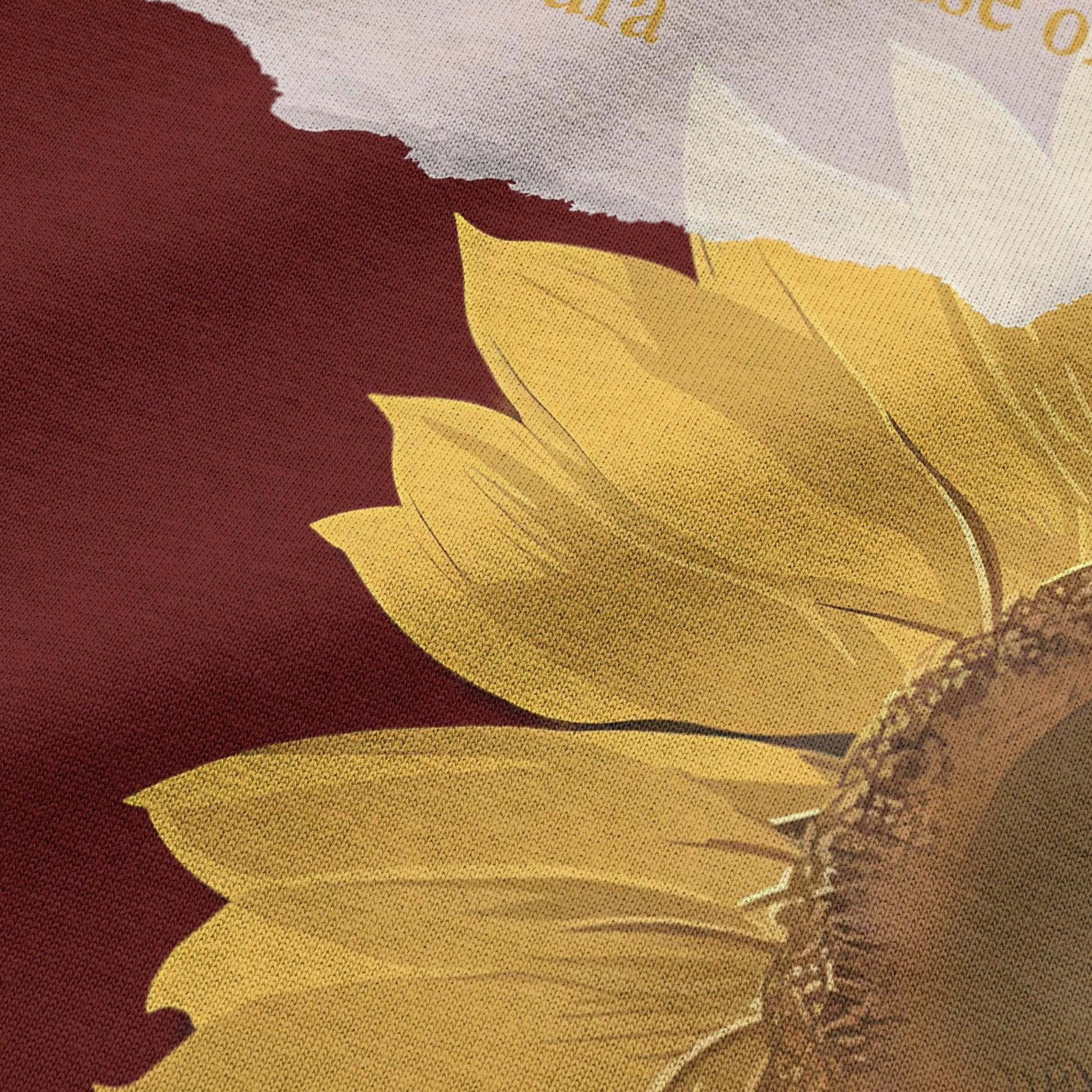 Close-up of sunflower graphic print on wine oversized t-shirt by BLAACK